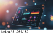 A digital tablet displaying colorful data visualizations and graphs. The background features soft bokeh lights, creating a modern tech atmosphere. Стоковое AI-видео, аниматор Nart / Фотобанк Лори