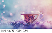 A clear glass cup filled with lavender tea sits on a soft, colorful background. Lavender flowers surround the cup, creating a calming atmosphere. Стоковое AI-видео, аниматор Nart / Фотобанк Лори