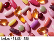 Medicine Pills on Pink Background. Medicinal Capsules and Tablets for Health. Vitamin and health supplement, colorful pills various types multivitamins and tablets. Antiviral, pharmaceutical products. Стоковое AI-изображение, AI-художник Марина Демидюк / Фотобанк Лори