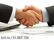 Business partnership established through a handshake during a meeting. Стоковое AI-изображение, AI-художник Katsiaryna Repich / Фотобанк Лори