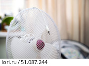 Electric plug hanging from a fan grill, symbolizing the end of hot weather and switched-off appliance. Стоковое фото, фотограф Татьяна Степанищева / Фотобанк Лори