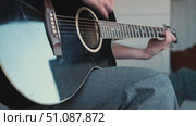 Woman Practicing Guitar in Cozy Room at Home. Strumming black acoustic guitar. Female learning to play music. Person hand on a guitar neck. Guitarist working on melody, performance, practice indoors. Стоковое видео, видеограф Марина Демидюк / Фотобанк Лори