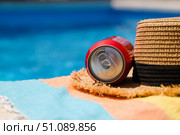 Poolside seat at the hotel. Cold drink and straw hat by the pool. Стоковое фото, фотограф Никита Бурденков / Фотобанк Лори