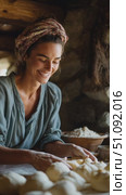 Woman joyfully prepares dough in rustic kitchen, showcasing traditional baking techniques and culture. Стоковое AI-видео, аниматор Сергей Толмачёв / Фотобанк Лори