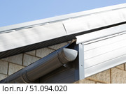 Modern guttering on a modern roof. Roof drainage. Стоковое фото, фотограф Александр Поташев / Фотобанк Лори