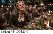Joyful character enjoying festivities in a medieval tavern filled with laughter and warmth. Стоковое AI-изображение, AI-художник Ксения Лаптева / Фотобанк Лори