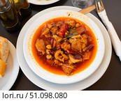 Portion of stewed tripe with chickpea is cooked in plate - stomach of cattle. Стоковое фото, фотограф Яков Филимонов / Фотобанк Лори