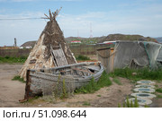 Деревянная лодка и чум на фоне городского пейзажа. Стоковое фото, фотограф Вероника Куденцова / Фотобанк Лори