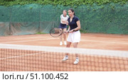 Young woman playing tennis against opponent. Стоковое видео, видеограф Яков Филимонов / Фотобанк Лори