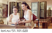 Visitors stands near horizontal glass display case and examines valuable exhibit. Стоковое видео, видеограф Яков Филимонов / Фотобанк Лори
