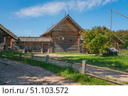 View of an ancient log building on the territory of the Pushkin village in Bugrovo of the Pushkin Museum-Reserve on a sunny summer day, Pushkinskiye Gory, Pskov region, Russia. Стоковое фото, фотограф Ula Ulachka / Фотобанк Лори