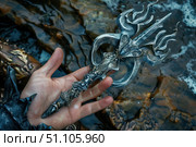 Hand holding fantasy artifact near water stream. Стоковое AI-изображение, AI-художник Иван Рябоконь / Фотобанк Лори