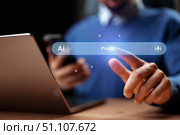 Person interacting with a laptop and smartphone while using artificial intelligence technology for prompt generation. Стоковое фото, фотограф Сергей Толмачёв / Фотобанк Лори