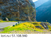 Landscape with a turn of a mountain road on a rocky ledge with a steep cliff into a deep abyss in the mountains of the North Caucasus. Стоковое фото, фотограф Константин Лабунский / Фотобанк Лори