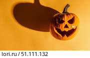 An Eerie, Spooky Halloween Pumpkin Lantern featuring a Menacing Face and Haunting Shadows that Create Atmosphere. Стоковое AI-изображение, AI-художник Anastasy Yarmolovich / Фотобанк Лори