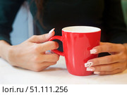 A cup of coffee in a woman's hands. Сoffee with cream. Стоковое фото, фотограф Наталия Кирсанова / Фотобанк Лори