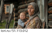 Деревенская бабушка держит малыша-внука на руках. Ретро. A village grandmother holds her baby grandson in her arms. Retro. Стоковое AI-изображение, AI-художник Смирнова Светлана / Фотобанк Лори