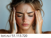 Woman Experiencing Headache While Sitting Indoors, Showcasing Discomfort and Stress. Стоковое AI-изображение, AI-художник Юлия Гапеенко / Фотобанк Лори