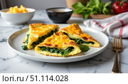 Cheddar and spinach omelette slices on white plate with greens. Стоковое AI-изображение, AI-художник DeFusum / Фотобанк Лори