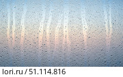 Abstract background of water drops on glass window with beautiful sunrise gradient. Closeup of rain condensation texture for calm and fresh wallpaper design. Стоковое AI-изображение, AI-художник Павел Муравьев / Фотобанк Лори