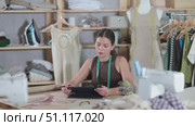 Female dressmaker working on digital sketch of dress in workshop. Стоковое видео, видеограф Яков Филимонов / Фотобанк Лори