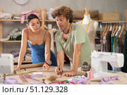 Female and male dressmakers drawing on paper in sewing studio. Стоковое фото, фотограф Яков Филимонов / Фотобанк Лори