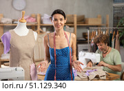 Positive woman working with mannequin and man sewing. Стоковое фото, фотограф Яков Филимонов / Фотобанк Лори