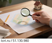 Человек с лупой изучает план застройки участка / A man with a magnifying glass examines the building plan of the site. Стоковое AI-изображение, AI-художник Валерий Лукин / Фотобанк Лори