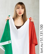 Sad young woman holding flag of Italy against unicoloured background. Стоковое фото, фотограф Яков Филимонов / Фотобанк Лори