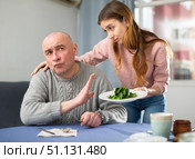 Portrait of a disgruntled man, to whom a young woman brought a plate of spinach. Стоковое фото, фотограф Яков Филимонов / Фотобанк Лори