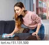 Young woman wipes the table with a damp rag. Стоковое фото, фотограф Яков Филимонов / Фотобанк Лори