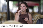 Pretty woman relaxing and drinking coffee sitting on street cafe of Barcelona in summer day. Стоковое видео, видеограф Яков Филимонов / Фотобанк Лори