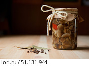 Bank of pickled mushrooms honey agarics standing on a wooden table surface. Стоковое фото, фотограф Наталия Кирсанова / Фотобанк Лори