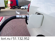 Refuel cars at the fuel pump. The driver hands, refuel and pump the car's gasoline with fuel at the petrol station. Car refueling at a gas station. Стоковое фото, фотограф Ирина Михайличенко / Фотобанк Лори