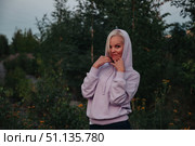 Enchanting Woman in Lavender Hoodie Enjoys Dusk in the Woods. Стоковое фото, фотограф Aleksandr Golubev / Фотобанк Лори