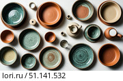 Set of handmade ceramic tableware on table top view. Стоковое AI-изображение, AI-художник Анна Никонорова / Фотобанк Лори