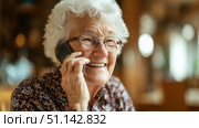Пожилая женщина разговаривает по телефону дома. An elderly woman is talking on the phone at home. Стоковое AI-изображение, AI-художник Смирнова Светлана / Фотобанк Лори