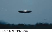 A glowing object silently hovers above a forest clearing at twilight. Стоковое AI-видео, аниматор Данила Большаков / Фотобанк Лори