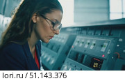 A skilled technician adjusts machinery settings in a modern control room. Стоковое AI-видео, аниматор Данила Большаков / Фотобанк Лори