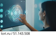 A person engages with a high-tech display using touch gestures in a contemporary office setting. Стоковое AI-видео, аниматор Данила Большаков / Фотобанк Лори