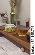 Chinese Tea ceremony at home. Hot Herbal tea in glass teapot and cup. Slow motion vertical footage. Стоковое видео, видеограф Ирина Михайличенко / Фотобанк Лори