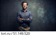 Confident Man Standing Tall Against A Gray Background. Generative AI. Стоковое AI-изображение, AI-художник Roman Zavorotny / Фотобанк Лори