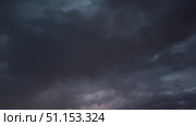 Video of sky landscape with black thunder clouds in the sky with bright flashes and lightning during storm and thunder rain in summer. Natural sky background. Weather forecast. Natural phenomena. Стоковое видео, видеограф Виктория Катьянова / Фотобанк Лори