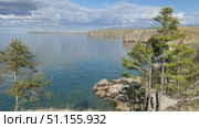 Baikal Lake on sunny summer day. Video of shallow bay of Small Sea and  beach of Olkhon island. Scenic landscape with larch trees. Natural background. Summer travels. Стоковое видео, видеограф Виктория Катьянова / Фотобанк Лори
