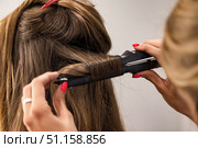 Creating Bouncy Curls a Hairdresser Styles Long Hair in a Salon. Стоковое фото, фотограф Aleksandr Golubev / Фотобанк Лори
