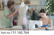 Man tailor connects parts of dress on mannequin, woman craftsman tailor work and sewing. Стоковое видео, видеограф Яков Филимонов / Фотобанк Лори