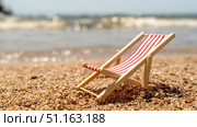 Mini sun lounger on the beach by the sea. The concept of recreation and holidays at the sea. Стоковое фото, фотограф Igor Skripachev / Фотобанк Лори