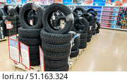 Vladimir, Russia, July 24, 2025: Winter tires at Auchan hypermarket. Редакционное фото, фотограф Igor Skripachev / Фотобанк Лори