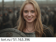 A young Viking woman with a shield. Стоковое AI-изображение, AI-художник Александр Поташев / Фотобанк Лори