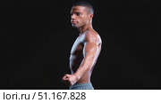 Muscular male athlete spinning, highlighting anatomical definition of back and front muscle groups against dark minimalist backdrop, demonstrating peak physical conditioning. Стоковое AI-видео, аниматор Юрий Поздников / Фотобанк Лори